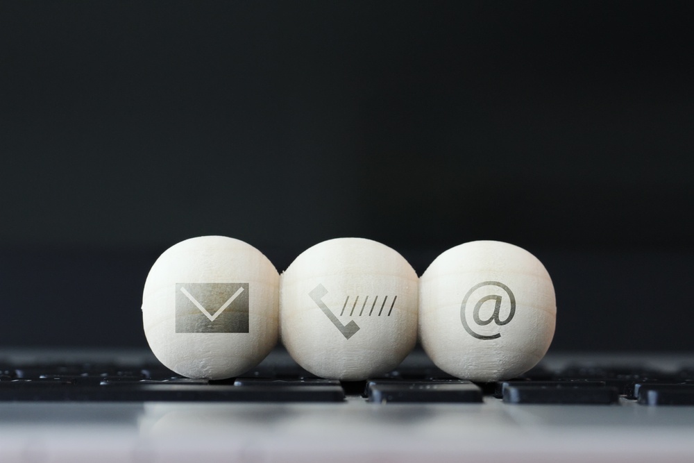 Icon On Wooden Ball Of Website And Internet Contact Us Page Concept On Computer Laptop Keyboard